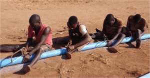 Cutting borehole pipes in Kigoma